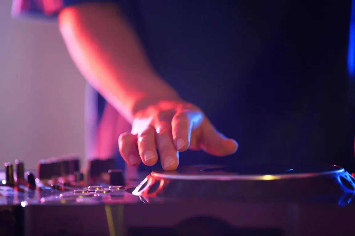 DJ hands on mixer